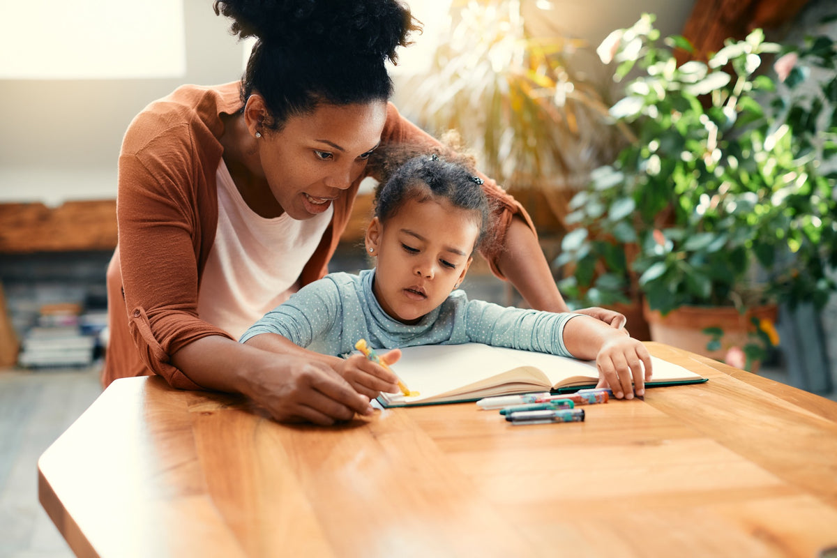 Classical preschool homeschooling mom drawing with her child
